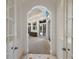 Hallway through archway and double doors shows a view to the backyard, pool and sitting area at 19208 Ganton Ave, Lakewood Ranch, FL 34202