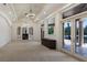 Spacious living area with tray ceilings, an elegant chandelier, and large windows bringing in natural light at 19208 Ganton Ave, Lakewood Ranch, FL 34202