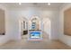 Bright living room featuring arched doorways and a built-in display for multiple TV screens at 19208 Ganton Ave, Lakewood Ranch, FL 34202
