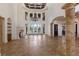 Spacious living room with high ceilings, large windows, stone columns and fireplace at 19208 Ganton Ave, Lakewood Ranch, FL 34202