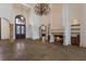 Grand living space with a stone fireplace, high ceilings, and elegant chandelier lighting at 19208 Ganton Ave, Lakewood Ranch, FL 34202