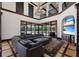 Open living room boasts soaring ceilings, wall of windows, and designer finishes at 19208 Ganton Ave, Lakewood Ranch, FL 34202