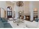 Elegant living room featuring a fireplace, chandelier, and ample seating for entertaining guests at 19208 Ganton Ave, Lakewood Ranch, FL 34202