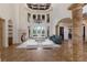 Spacious living room boasts soaring ceilings, fireplace, and large windows overlooking the lush greenery at 19208 Ganton Ave, Lakewood Ranch, FL 34202