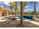 Resort-style pool and spa with fire bowls, lush landscaping, and direct access to a serene lake at 19208 Ganton Ave, Lakewood Ranch, FL 34202