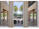 View of private backyard pool and patio, framed by the stately columns and grand architecture of the home at 19208 Ganton Ave, Lakewood Ranch, FL 34202