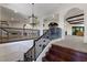 Elegant staircase features dark wood steps, a wrought iron banister, and a view of the upper landing at 19208 Ganton Ave, Lakewood Ranch, FL 34202