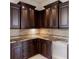 Wet bar area featuring custom cabinetry, granite countertops, and a stainless steel beverage fridge at 19208 Ganton Ave, Lakewood Ranch, FL 34202