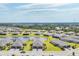Expansive aerial view of a residential community featuring a central lake and well-maintained landscaping at 2072 Mackerel St, Port Charlotte, FL 33953