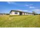 A spacious backyard with a lush green lawn, complemented by manicured landscaping, and a house at 2072 Mackerel St, Port Charlotte, FL 33953