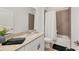 A well-lit bathroom with a granite countertop, modern fixtures, and a shower-tub combination with neutral tile at 2072 Mackerel St, Port Charlotte, FL 33953