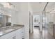 Bathroom with shower and view to the primary bedroom at 2072 Mackerel St, Port Charlotte, FL 33953