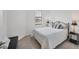 This bedroom features natural light and a comfortable queen bed with stylish lamps and flooring at 2072 Mackerel St, Port Charlotte, FL 33953