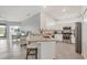 Bright, open kitchen features white cabinets, granite countertops, and stainless steel appliances at 2072 Mackerel St, Port Charlotte, FL 33953