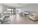 Bright living room with neutral furniture, tiled floors, large sliding glass doors, and a view of the outdoors at 2072 Mackerel St, Port Charlotte, FL 33953
