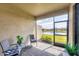 Relaxing screened patio with comfortable seating overlooking a peaceful outdoor view of a water feature at 2072 Mackerel St, Port Charlotte, FL 33953
