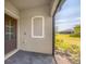 Outdoor porch with gray brick flooring and a screened-in area showcasing serene outdoor views at 2072 Mackerel St, Port Charlotte, FL 33953