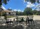 Cozy backyard seating area with charming wrought iron table and chairs, ideal for relaxing at 222 High Point Dr, Venice, FL 34292