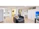 Cozy finished basement with tile floors, kitchenette, bathroom, and comfortable sitting area at 222 High Point Dr, Venice, FL 34292