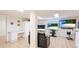 Finished basement featuring mounted TV screens, workspace, and ample storage for a relaxing retreat at 222 High Point Dr, Venice, FL 34292