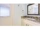 Bathroom with granite vanity, stylish sink, and decorative mirror at 222 High Point Dr, Venice, FL 34292
