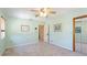 Comfortable bedroom featuring a ceiling fan, light blue walls and neutral carpeting at 222 High Point Dr, Venice, FL 34292