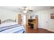 This bedroom offers a ceiling fan and a desk with french doors leading into another room at 222 High Point Dr, Venice, FL 34292