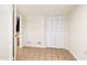 Simple bedroom with tile flooring and a closet, offering functional space at 222 High Point Dr, Venice, FL 34292