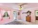 Cozy pink bedroom with a view to an outdoor deck and large window showcasing the property at 222 High Point Dr, Venice, FL 34292
