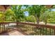 Open-air wooden deck providing a view to the tree-lined streets and lush yard surrounding the property at 222 High Point Dr, Venice, FL 34292