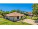 Exterior shot of home with green grass and palm trees in the front yard at 222 High Point Dr, Venice, FL 34292