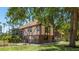 Charming two-story home with Tudor-style accents, a brick foundation, and mature trees at 222 High Point Dr, Venice, FL 34292