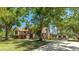 Elegant two-story home featuring a balcony, lush lawn, and a long driveway leading to a private retreat at 222 High Point Dr, Venice, FL 34292