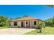 Well-maintained home with a paver driveway and verdant landscaping at 222 High Point Dr, Venice, FL 34292