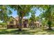 Charming two-story home with a well-manicured lawn and mature trees in a serene outdoor setting at 222 High Point Dr, Venice, FL 34292