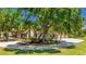 Beautifully landscaped home featuring a circular driveway and lush greenery, offering a serene and private setting at 222 High Point Dr, Venice, FL 34292