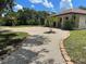 Inviting front yard with well-manicured landscaping and a circular driveway at 222 High Point Dr, Venice, FL 34292