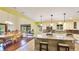 Spacious eat-in kitchen featuring island with seating, stainless appliances and white cabinetry at 222 High Point Dr, Venice, FL 34292