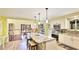 Open kitchen with stainless steel appliances, granite countertops, and eat-in island at 222 High Point Dr, Venice, FL 34292