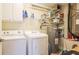 Well-equipped laundry area with washer, dryer, and convenient shelving for storage at 222 High Point Dr, Venice, FL 34292