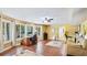 Sunny living room with wood floors, large windows, and open concept layout at 222 High Point Dr, Venice, FL 34292
