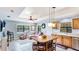 Open concept living room and kitchen area with natural lighting, tile floors, and comfortable seating at 222 High Point Dr, Venice, FL 34292