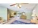 Spacious main bedroom with carpet floors, ceiling fan, with ensuite bathroom and walk-in closet at 222 High Point Dr, Venice, FL 34292