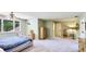 Spacious main bedroom boasts light green walls, a large window, ceiling fan and neutral carpet flooring at 222 High Point Dr, Venice, FL 34292