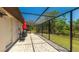 Enclosed patio with stone flooring, outdoor seating, and screened enclosure at 222 High Point Dr, Venice, FL 34292