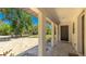 Covered front porch with elegant columns and a brick-paved walkway at 222 High Point Dr, Venice, FL 34292