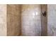 Shower space features a floor-to-ceiling tile surround, and sleek fixtures at 222 High Point Dr, Venice, FL 34292