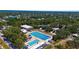 Aerial view showcasing a community swimming pool in a lush, residential neighborhood at 2632 Hawthorne St, Sarasota, FL 34239