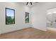 Bright bedroom featuring wood floors, two windows and an attached bathroom at 2632 Hawthorne St, Sarasota, FL 34239