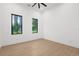 Bright bedroom with wood floors, two windows and neutral walls at 2632 Hawthorne St, Sarasota, FL 34239